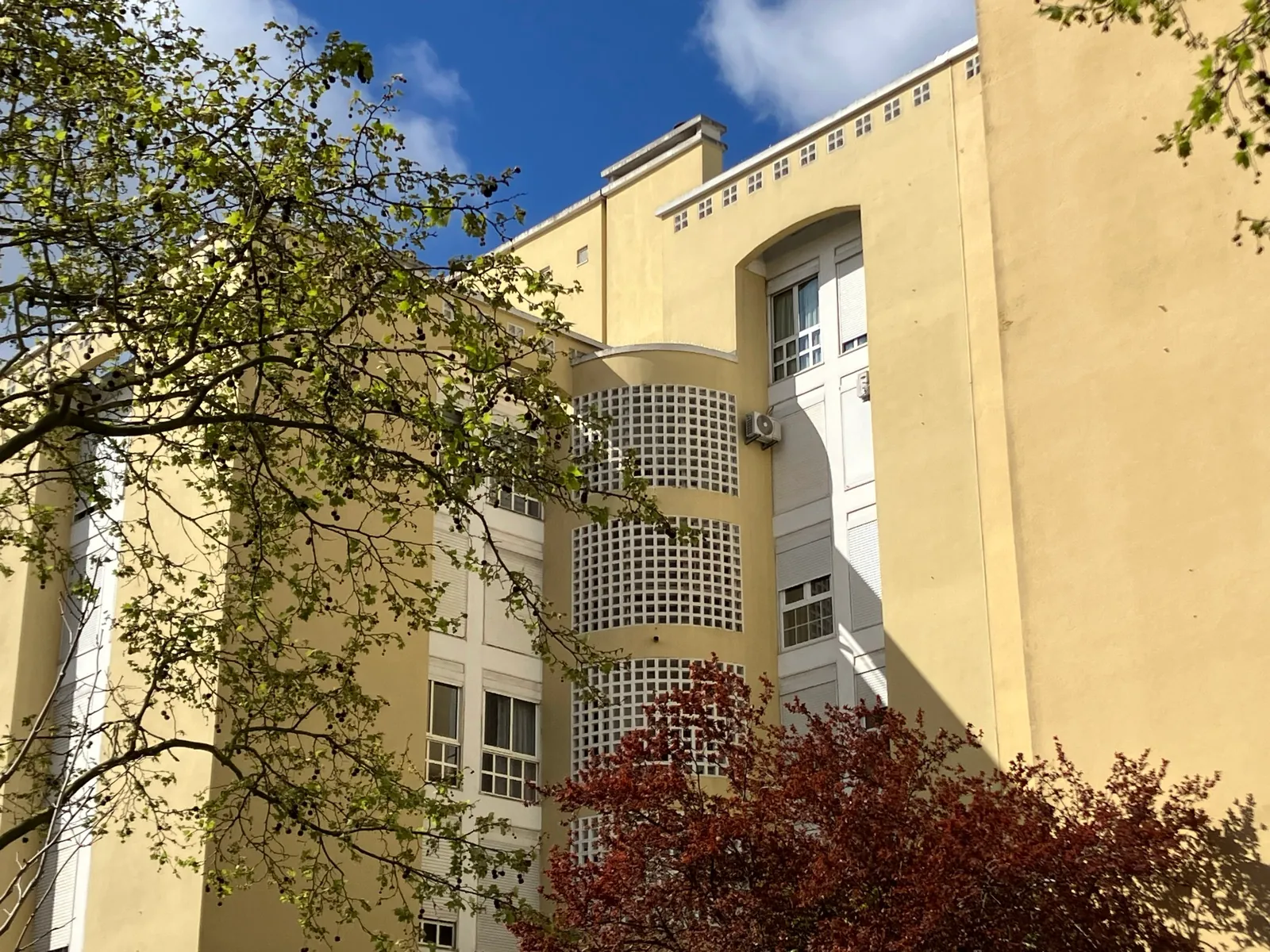 Fachada amarela de edifícios residenciais na Rua Hermano Neves, em Telheiras, fotografada em março de 2025.